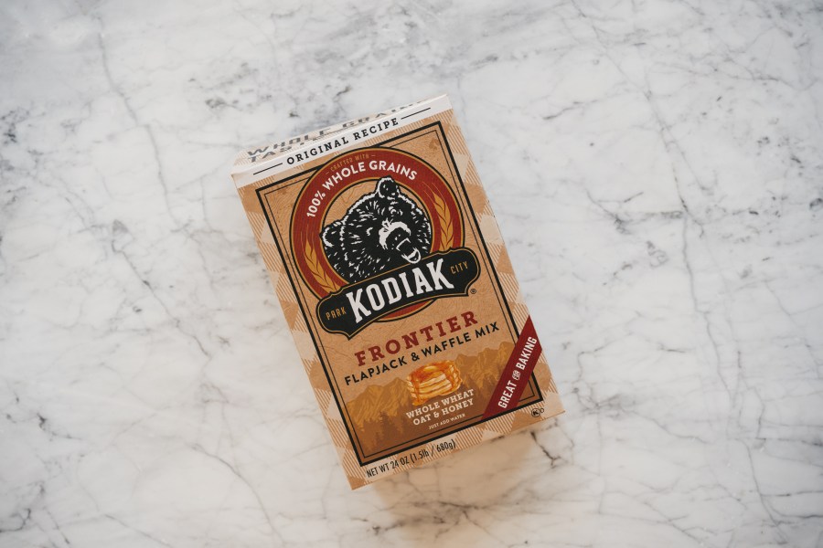 a white marble table with a box of Kodiak Cakes Pancake Mix